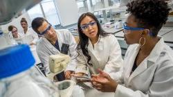 3 students running experiment in laboratory